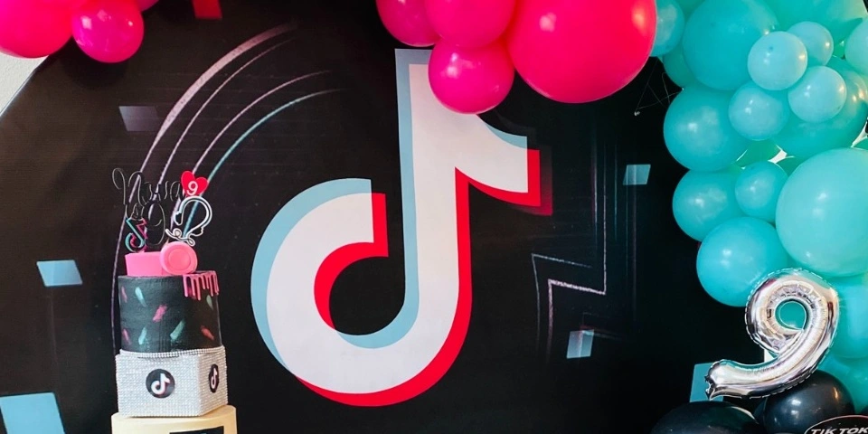 A birthday party with colorful balloons and a TikTok logo, celebrating the creation of this blog.